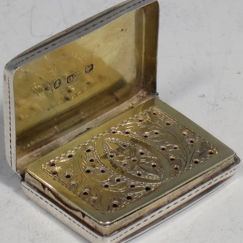 An Antique Georgian Sterling silver vinaigrette, having hand-engraved floral decoration, a gold-gilt interior, and a hand-pierced grill with floral work. Made by Gervais Wheeler of Birmingham in 1836. The dimensions of this fine hand-made silver vinaigrette are length 3.2 cms (1.3 inches), width 2.5 cms (1 inch), and depth 0.7 cm (0.3 inches).   