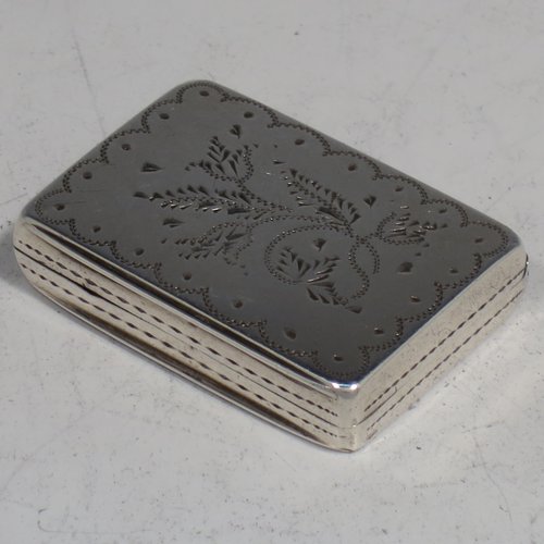 An Antique Georgian Sterling silver vinaigrette, having hand-engraved floral decoration, a gold-gilt interior, and a hand-pierced grill with floral work. Made by Gervais Wheeler of Birmingham in 1836. The dimensions of this fine hand-made silver vinaigrette are length 3.2 cms (1.3 inches), width 2.5 cms (1 inch), and depth 0.7 cm (0.3 inches).   