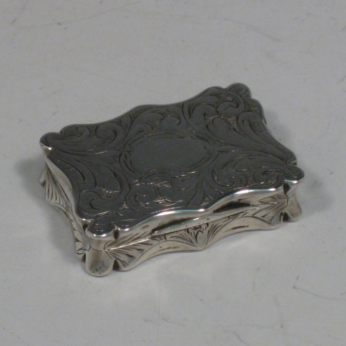 Antique Victorian sterling silver vinaigrette, having a rectangular shaped body with hand-engraved floral decoration and a vacant cartouche, a hinged lid, and a gold-gilt interior with hinged hand-pierced and chased grill. Made by Edward Smith of Birmingham in 1843. The dimensions of this fine hand-made silver vinaigrette are length 3.5 cms (1.3 inches), and width 2.5 cms (1 inch).    