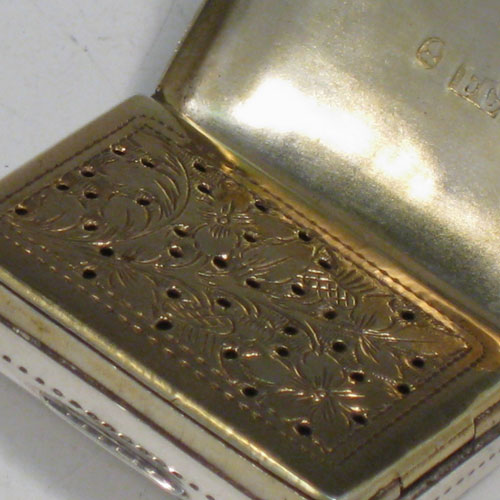    Antique Georgian sterling silver vinaigrette, having a rectangular body with hand-engraved floral decoration and a vacant cartouche, a hinged lid, a gold-gilt interior with hinged hand-chased grill. Made by Francis Clark, of Birmingham in 1834. The dimensions of this fine hand-made silver vinaigrette are length 3 cms (1.25 inches), and width 2 cms (0.75 inches).   