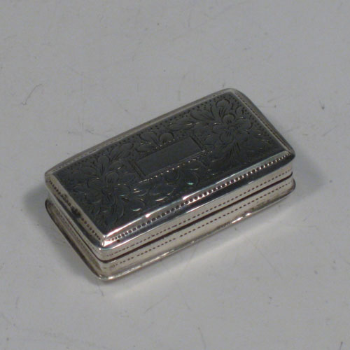 Antique Georgian sterling silver vinaigrette, having a rectangular body with hand-engraved floral decoration, a hinged lid, a gold-gilt interior with hinged sun-burst grill. Made by Lawrence & Co., of Birmingham in 1831. The dimensions of this fine hand-made silver vinaigrette are length 3.2 cms (1.25 inches), and width 1.7 cms (0.5 inches).