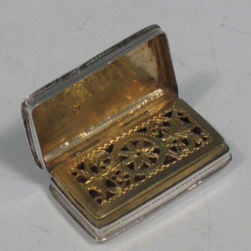 Antique Georgian sterling silver vinaigrette, having a rectangular body with hand-engraved floral decoration, a hinged lid, a gold-gilt interior with hinged sun-burst grill. Made by Lawrence & Co., of Birmingham in 1831. The dimensions of this fine hand-made silver vinaigrette are length 3.2 cms (1.25 inches), and width 1.7 cms (0.5 inches).