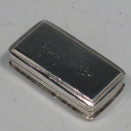 Antique Georgian sterling silver vinaigrette, having a rectangular body with hand-engraved floral decoration, a hinged lid, a gold-gilt interior with hinged sun-burst grill. Made by Lawrence & Co., of Birmingham in 1831. The dimensions of this fine hand-made silver vinaigrette are length 3.2 cms (1.25 inches), and width 1.7 cms (0.5 inches).