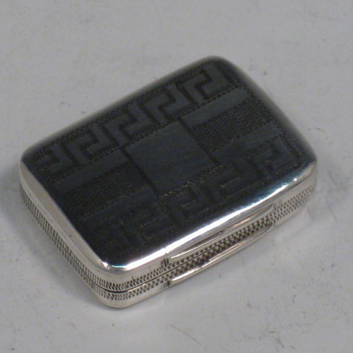 Antique Georgian sterling silver vinaigrette, having a rectangular body with hand-engraved Greek-Key decoration, a hinged lid, and a gold-gilt interior with hinged fillagree grill. Made by Samuel Pemberton of Birmingham in 1805. The dimensions of this fine hand-made silver vinaigrette are length 2.5 cms (1 inches), and width 2 cms (0.75 inches).   