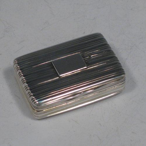 Antique Georgian sterling silver vinaigrette, having a rectangular body with hand-engraved reeded decoration and vacant cartouche, a hinged lid, a gold-gilt interior with hinged hand-pierced and chased grill with floral decoration. Made by Nathaniel Mills of Birmingham in 1828. The dimensions of this fine hand-made silver vinaigrette are length 4 cms (1.5 inches), and width 2.5 cms (1 inch).    