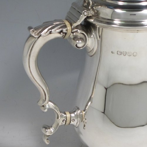 Antique Victorian sterling silver water or beer jug, having a plain round baluster body, with insulated scroll handle, a hinged domed lid with hand-pierced thumb-piece, a spout with hand-chased Bacchus face, a gold-gilt interior, and all sitting on a collet foot. Made by Robert Hennell of London in 1871. The dimensions of this fine hand-made silver beer or water jug are height 21 cms (8.25 inches), length 20 cms (8 inches), and it weighs approx. 777g (25 troy ounces).