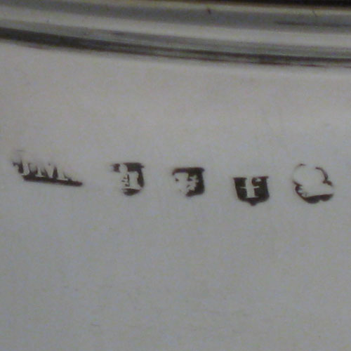 A large and very handsome Antique Georgian Sterling Silver water or beer jug, having a round body with hand-chased half-fluted decoration, plain pouring spout, an insulated scroll handle, a hinged domed lid with cast acanthus leaf thumb-piece, and sitting on a plain round pedestal foot. Made by J. McKay of Edinburgh in 1811. The dimensions of this fine hand-made antique silver beer or water jug are height 23 cms (9 inches), length 26 cms (10.25 inches), and it weighs approx. 991g (32 troy ounces)