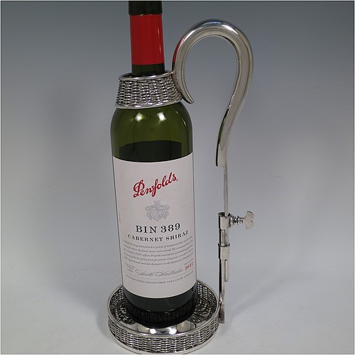 An Antique Victorian Silver Plated wine bottle cradle or holder, having a round straight-sided base with basket-weave hand-pierced decoration, a plain sliding scroll handle with matching basket weave neck and retaining screw. Made by J. and B. of Sheffield in ca. 1870. The dimensions of this fine hand-made antique silver-plated wine bottle holder or cradle are height 26 cms (10 inches), or 33 cms (13 inches) extended, and diameter of base 11.5 cms (4.5 inches). Please note that this wine bottle cradle or holder will accept a 75cl bottle, (bottle shown for display purposes only).   