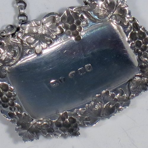 An Antique Victorian Sterling Silver wine decanter label, having a shaped rectangular body, with applied grape and vine-leaf border, hand-engraved for Sherry, and with its original bottle chain. Made by Joseph Wilmore of Birmingham in 1840. The dimensions of this fine hand-made antique silver decanter wine label are height 3.5 cms (1.3 inches), length 4.5 cms (1.75 inches), and it weighs approx. 12g (0.38 troy ounces).    