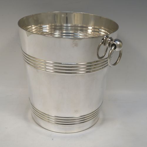 A very handsome Antique French Silver Plated wine bottle cooler, having a plain round body with tapering sides, with two bands of hand-engraved reeded decoration, and two cast ring side-handles, all sitting on a flat base. Made in ca. 1930 by the French silversmith Christophle. The dimensions of this fine hand-made antique silver-plated wine cooler are height 20 cms (8 inches), and diameter at lip 19 cms (7.5 inches). Please note that this will easily hold a magnum size bottle.  