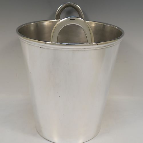 A large and very elegant Art Deco style Silver Plated wine bottle cooler, having a plain round body with tapering sides, and two cast loop side-handles, all sitting on a flat base. This beautiful silver-plated wine cooler was made in ca. 1930. The dimensions of this fine hand-made silver-plated Art Deco wine cooler are height 27 cms (10.5 inches), and diameter at lip 22 cms (8.75 inches). Please note that this will easily hold two normal size wine  bottles.  