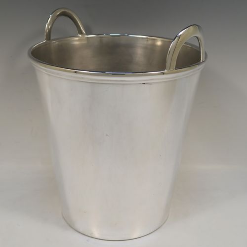 A large and very elegant Art Deco style Silver Plated wine bottle cooler, having a plain round body with tapering sides, and two cast loop side-handles, all sitting on a flat base. This beautiful silver-plated wine cooler was made in ca. 1930. The dimensions of this fine hand-made silver-plated Art Deco wine cooler are height 27 cms (10.5 inches), and diameter at lip 22 cms (8.75 inches). Please note that this will easily hold two normal size wine  bottles.  