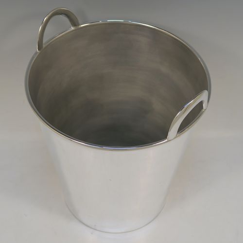 A large and very elegant Art Deco style Silver Plated wine bottle cooler, having a plain round body with tapering sides, and two cast loop side-handles, all sitting on a flat base. This beautiful silver-plated wine cooler was made in ca. 1930. The dimensions of this fine hand-made silver-plated Art Deco wine cooler are height 27 cms (10.5 inches), and diameter at lip 22 cms (8.75 inches). Please note that this will easily hold two normal size wine  bottles.  