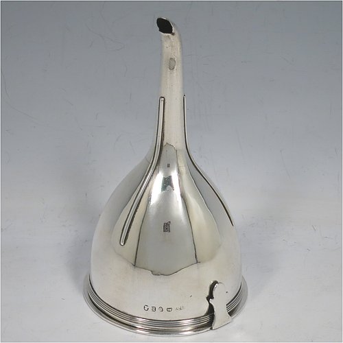 An Antique Georgian Sterling Silver wine decanting funnel, having a round body with applied reeded border and funnel struts (that allow proper aeration when decanting), a pull out strainer with a shaped clip, and an original muslin ring. Made by Alexander Field of London in 1801. Crested. The dimensions of this fine hand-made antique silver wine decanting funnel are height 14.5 cms (5.75 inches), diameter of cup 8 cms (3.25 inches), and it weighs approx. 155g (5 troy ounces).   