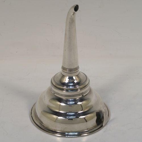 A very handsome Antique Georgian Sterling Silver wine decanting funnel, having a plain round body with applied reeded borders, an original muslin ring and a side clip, and original removable funnel. This elegant antique silver wine funnel was made by Elizabeth Morley of London in 1810. The dimensions of this fine hand-made antique silver wine decanting funnel are height 13 cms (5.25 inches), diameter of bowl 9 cms (3.5 inches), and it weighs approx. 102g (3.3 troy ounces).   