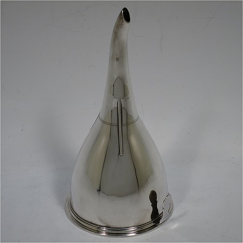 An Antique Georgian Sterling Silver wine decanting funnel, having a round plain body with applied reeded border and funnel struts (that allow proper aeration when decanting), a pull out hand-pierced strainer with an applied reeded border and shaped clip, and an original muslin ring. Made by William Bateman of London in 1820. The dimensions of this fine hand-made antique silver wine decanting funnel are height 16 cms (6.3 inches), diameter of cup 8.5 cms (3.3 inches), and it weighs approx. 158g (5 troy ounces).    