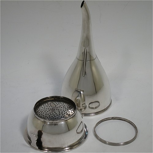 An Antique Georgian Sterling Silver wine decanting funnel, having a round plain body with applied reeded border and funnel struts (that allow proper aeration when decanting), a pull out hand-pierced strainer with an applied reeded border and shaped clip, and an original muslin ring. Made by William Bateman of London in 1820. The dimensions of this fine hand-made antique silver wine decanting funnel are height 16 cms (6.3 inches), diameter of cup 8.5 cms (3.3 inches), and it weighs approx. 158g (5 troy ounces).    