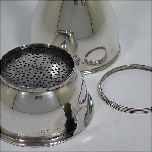 An Antique Georgian Sterling Silver wine decanting funnel, having a round plain body with applied reeded border and funnel struts (that allow proper aeration when decanting), a pull out hand-pierced strainer with an applied reeded border and shaped clip, and an original muslin ring. Made by William Bateman of London in 1820. The dimensions of this fine hand-made antique silver wine decanting funnel are height 16 cms (6.3 inches), diameter of cup 8.5 cms (3.3 inches), and it weighs approx. 158g (5 troy ounces).    