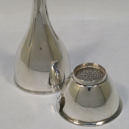 A very elegant Antique Georgian Sterling Silver wine decanting funnel, having a round plain body with an applied reeded border and funnel struts (that allow proper aeration when decanting), a pull out hand-pierced strainer with an applied reeded border and shaped clip. Made by Soloman Hougham of London in 1802. The dimensions of this fine hand-made antique silver wine decanting funnel are height 15 cms (6 inches), diameter of cup 8 cms (3.25 inches), and it weighs approx. 150g (4.8 troy ounces).   