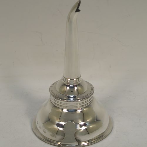 A handsome Sterling Silver wine decanting funnel, having a plain round body with applied bead borders, a plain side clip, and removable funnel. this elegant silver wine decanting funnel was made by A. Chick and Sons Ltd., of London in 1979. The dimensions of this fine hand-made silver wine decanting funnel are height 13.5 cms (5.3 inches), diameter of bowl 8 cms (3 inches), and it weighs approx. 66g (2 troy ounces).   