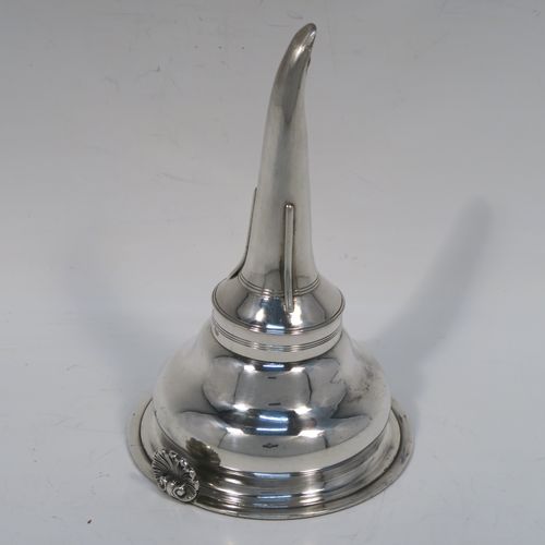 A very elegant Antique Georgian Sterling Silver wine decanting funnel, having a plain round body with applied reeded borders and a cast shell style side clip, an original muslin ring, and original removable funnel with side aeration struts. This handsome silver wine funnel was made by Emes and Barnard of London in 1819. The dimensions of this fine hand-made antique silver wine decanting funnel are height 13.5 cms (5.3 inches), diameter of bowl 9 cms (3.5 inches), and it weighs approx. 98g (3.2 troy ounces).   