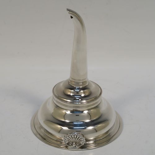 A very handsome Antique Georgian Sterling Silver wine decanting funnel, having a plain round body with an applied double feather-edged border and a cast shell style side clip, and original removable funnel. This elegant antique silver wine funnel was made in London in 1819. The dimensions of this fine hand-made antique silver wine decanting funnel are height 13 cms (5 inches), diameter of bowl 9.5 cms (3.75 inches), and it weighs approx. 102g (3.3 troy ounces).   