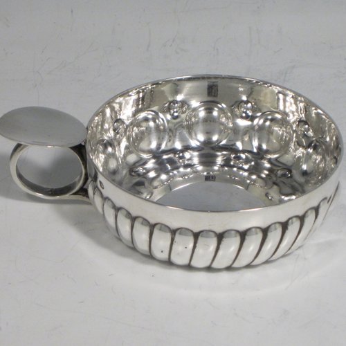 Antique Victorian Silver wine taster, having a round body, with hand-chased swirl-fluted decoration and punched bead-work, a loop handle with thumb-piece, and sitting on a concave base. Made in Paris, France ca. 1890, with a Minerva 2nd Quality mark, indicating 800 standard silver. The dimensions of this fine hand-made silver wine taster testavine are diameter 8 cms (3 inches), and height 2.5 cms (1 inch), and it weighs approx. 105g (3.4 troy ounces).