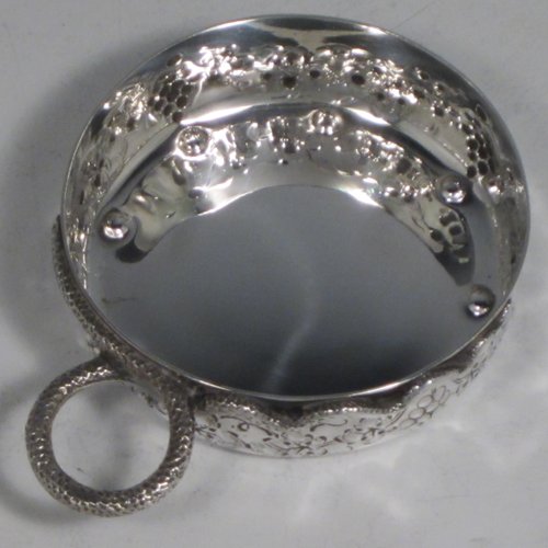 Antique Victorian Silver wine taster, having a round body, with hand-chased grape-vine decoration, a cast snake head loop handle, and sitting on a concave base with eight hand-chased beads running around the inside. Made in Paris, France ca. 1890, with a Minerva 1st Quality mark, indicating 950 standard silver. The dimensions of this fine hand-made silver wine taster testavine are diameter 8 cms (3 inches), and height 2.5 cms (1 inch), and it weighs approx. 87g (2.8 troy ounces).   