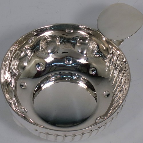 An Antique Victorian Silver French wine taster, having a round body, with hand-chased swirl-fluted and dimple decoration, a loop handle with plain thumb-piece, and sitting on a concave base with nine hand-chased beads running around the inside. Made in Paris, France ca. 1890, with a Minerva 1st Quality mark, indicating 950 standard silver. The dimensions of this fine hand-made antique silver wine taster or testavine are diameter 8 cms (3 inches), and height 3 cms (1.3 inch), and it weighs approx. 100g (3.2 troy ounces).    