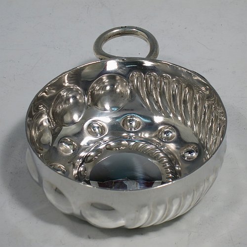 An Antique Victorian Silver French wine taster, having a round body, with hand-chased swirl-fluted decoration, a cast snake head loop handle, and sitting on a concave base with eleven hand-chased beads running around the inside. Made in Paris, France ca. 1890, with a Minerva 1st Quality mark, indicating 950 standard silver. The dimensions of this fine hand-made antique silver wine taster or testavine are diameter 8 cms (3 inches), and height 3 cms (1.3 inch), and it weighs approx. 90g (3 troy ounces).    