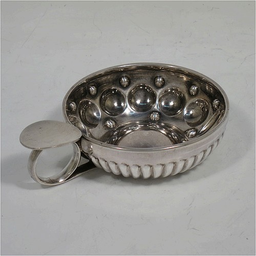 A very pretty Antique Victorian Silver wine taster, having a round body, with hand-chased fluted and ball decoration, a loop handle with thumb-piece, and sitting on a flat base. Made in Paris, France ca. 1890, with a Minerva 1st Quality mark, indicating 950 standard silver. The dimensions of this fine hand-made antique silver wine taster testavine are diameter 8 cms (3 inches), height 2.5 cms (1 inch), and it weighs approx. 69g (2.2 troy ounces).  