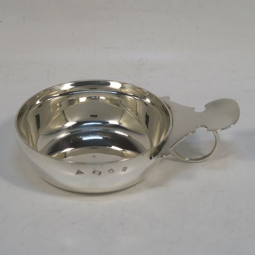 A very elegant Sterling Silver wine taster, having a plain round body with convex sides, a loop handle with thumb-piece, and sitting on a flat base. This handsome silver wine taster was made by J. A. Campbell of London in 1984. The dimensions of this fine hand-made silver wine taster testavine are diameter 8 cms (3 inches), height 2.5 cms (1 inch), and it weighs approx. 99g (3 troy ounces).   