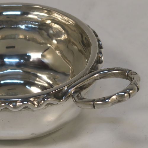 An Antique Victorian Silver French wine taster, having a plain round bellied body, a cast intertwined snake head loop handle, and sitting on a concave base. This elegant silver wine taster was made in Paris, France in ca. 1900, with a Minerva 1st Quality mark, indicating 950 standard silver. The dimensions of this fine hand-made antique silver wine taster or testavine are diameter 8 cms (3.25 inches), and height 3 cms (1.3 inch), and it weighs approx. 83g (2.7 troy ounces).  