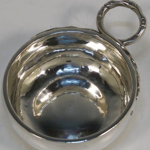 An Antique Victorian Silver French wine taster, having a plain round bellied body, a cast intertwined snake head loop handle, and sitting on a concave base. This elegant silver wine taster was made in Paris, France in ca. 1900, with a Minerva 1st Quality mark, indicating 950 standard silver. The dimensions of this fine hand-made antique silver wine taster or testavine are diameter 8 cms (3.25 inches), and height 3 cms (1.3 inch), and it weighs approx. 83g (2.7 troy ounces).  